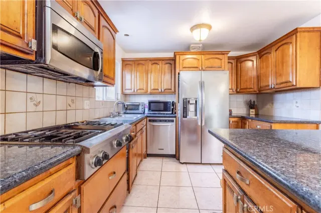 a bedroom with a bed couch and wooden floor