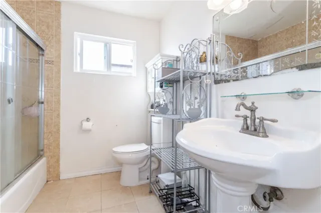 a bathroom with a granite countertop toilet a sink and bathtub