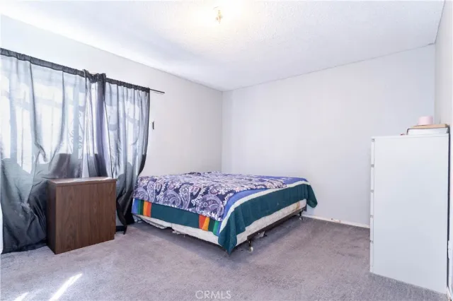 a bedroom with a large bed and a dresser