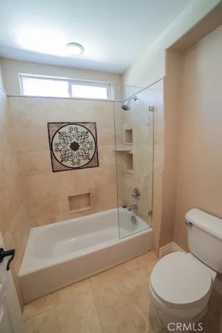a bathroom with a toilet and a bathtub