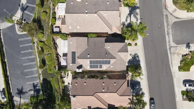 an aerial view of a house with a yard