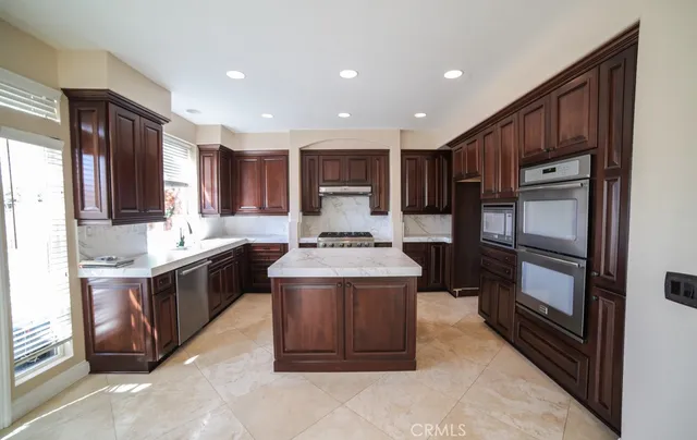 a kitchen with a stove sink and a refrigerator