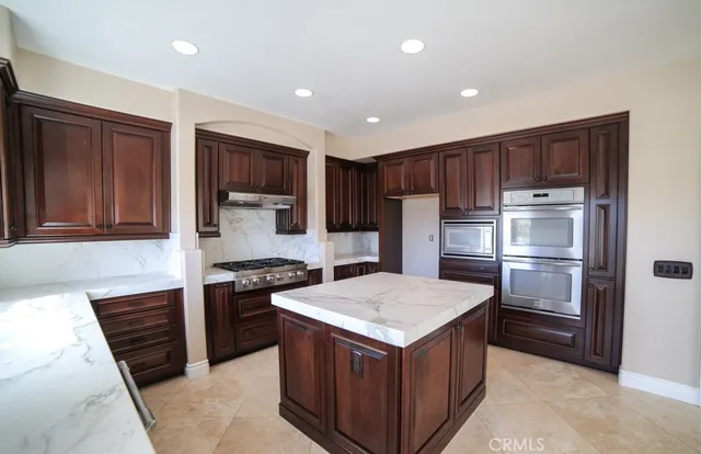 a kitchen with a sink and stainless steel appliances