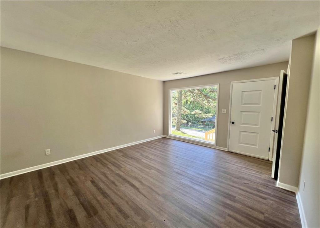 3706 Larkspur Terrace Decatur, GA 30032 - Photo 2 of 10 a view of an empty room with wooden floor and a window