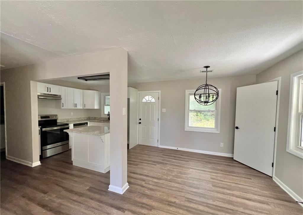 3706 Larkspur Terrace Decatur, GA 30032 - Photo 3 of 10 a view of empty room with wooden floor and kitchen