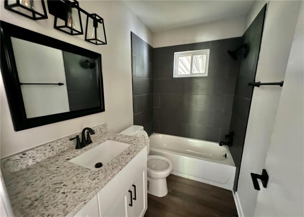3706 Larkspur Terrace Decatur, GA 30032 - Photo 6 of 10 a bathroom with a sink a toilet and mirror