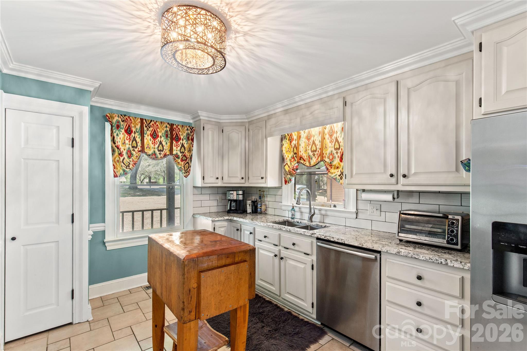 529 Langley Road Lancaster, SC 29720 - Photo 23 of 48 a kitchen with stainless steel appliances granite countertop a sink a stove cabinets dining table and chairs