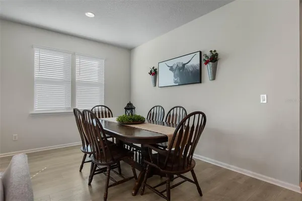 a view of a dining room with furniture and window