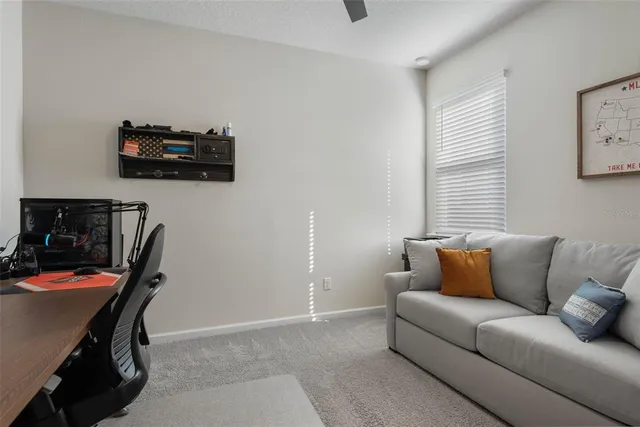 a living room with furniture a flat screen tv and a window