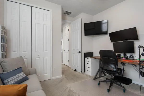 a view of a livingroom with workspace and a couch
