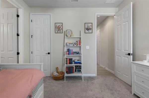 a bedroom with a bed and a cabinet