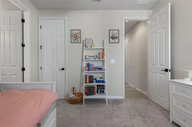 a bedroom with a bed and a cabinet