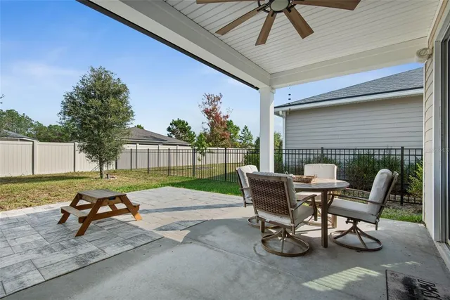 a view of backyard with a table and chairs