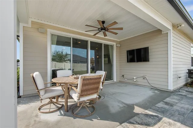 a patio with a table and chairs