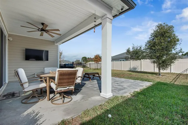 a view of a patio with a table and chairs