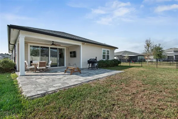 a view of a house with backyard and sitting area