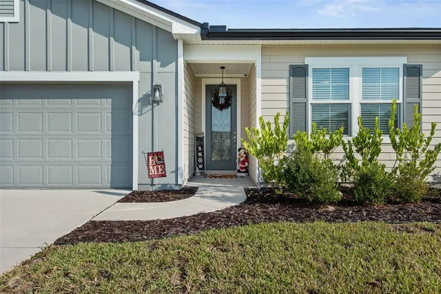 a view of a house with potted plants