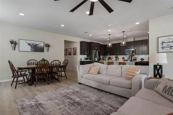 a living room with furniture kitchen view and a dining table