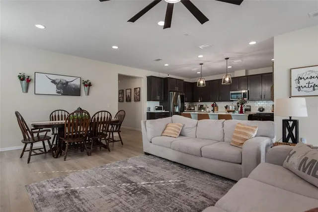 a living room with furniture kitchen view and a dining table