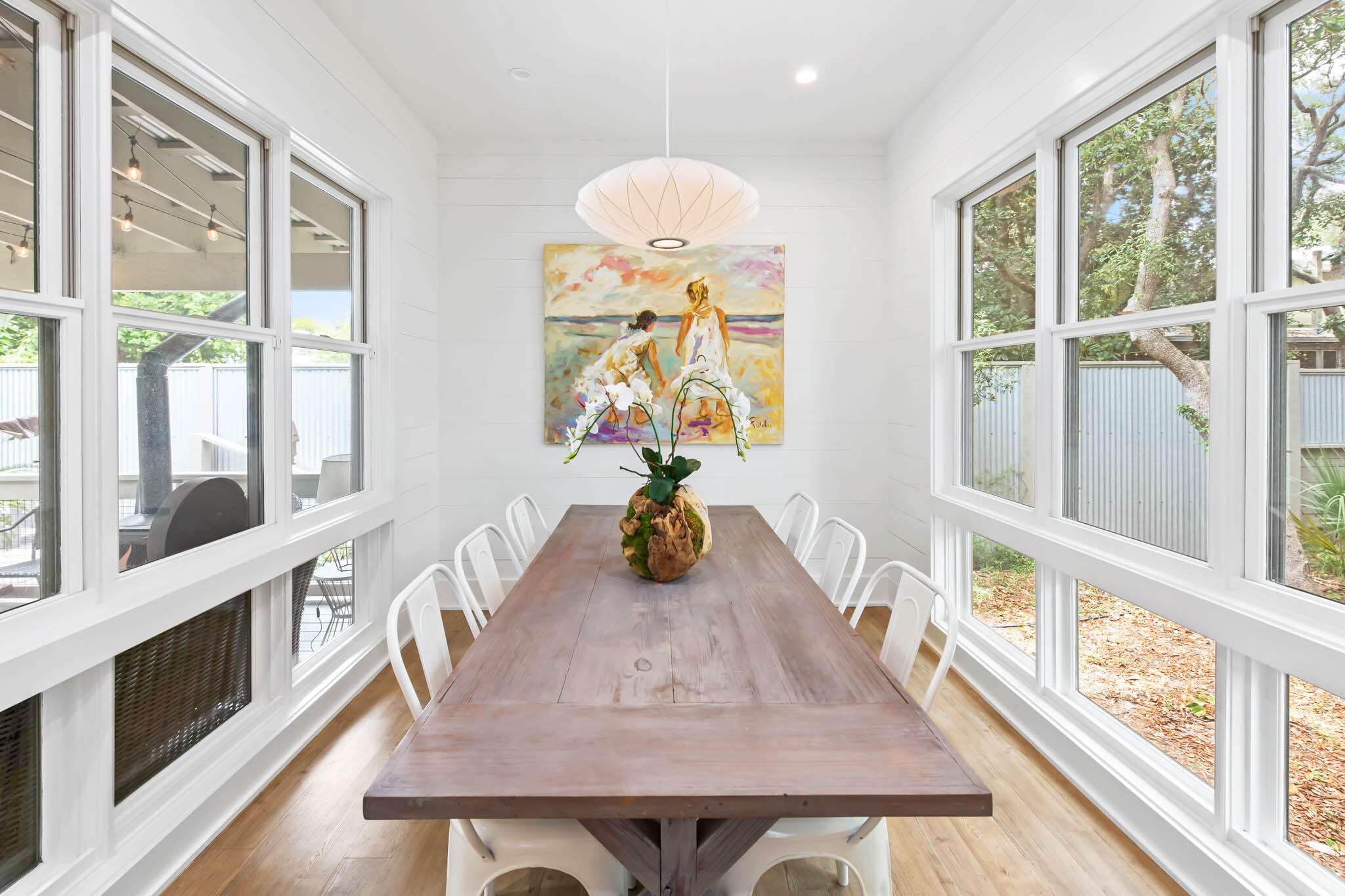 450 Defuniak Street Santa Rosa Beach, FL 32459 - Photo 29 of 75 a view of a dining room with furniture a chandelier and wooden floor