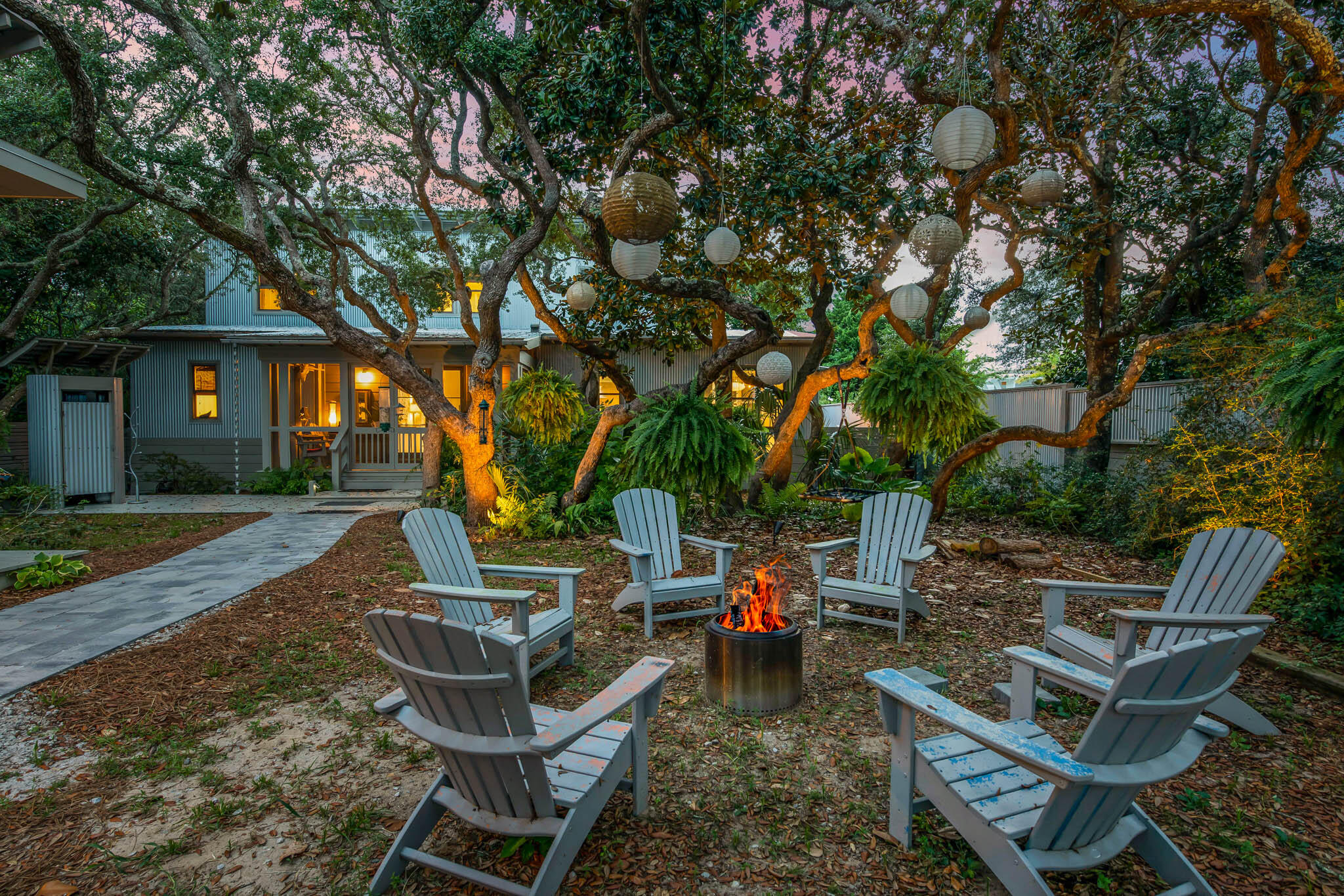 450 Defuniak Street Santa Rosa Beach, FL 32459 - Photo 4 of 75 a backyard of a house with table and chairs