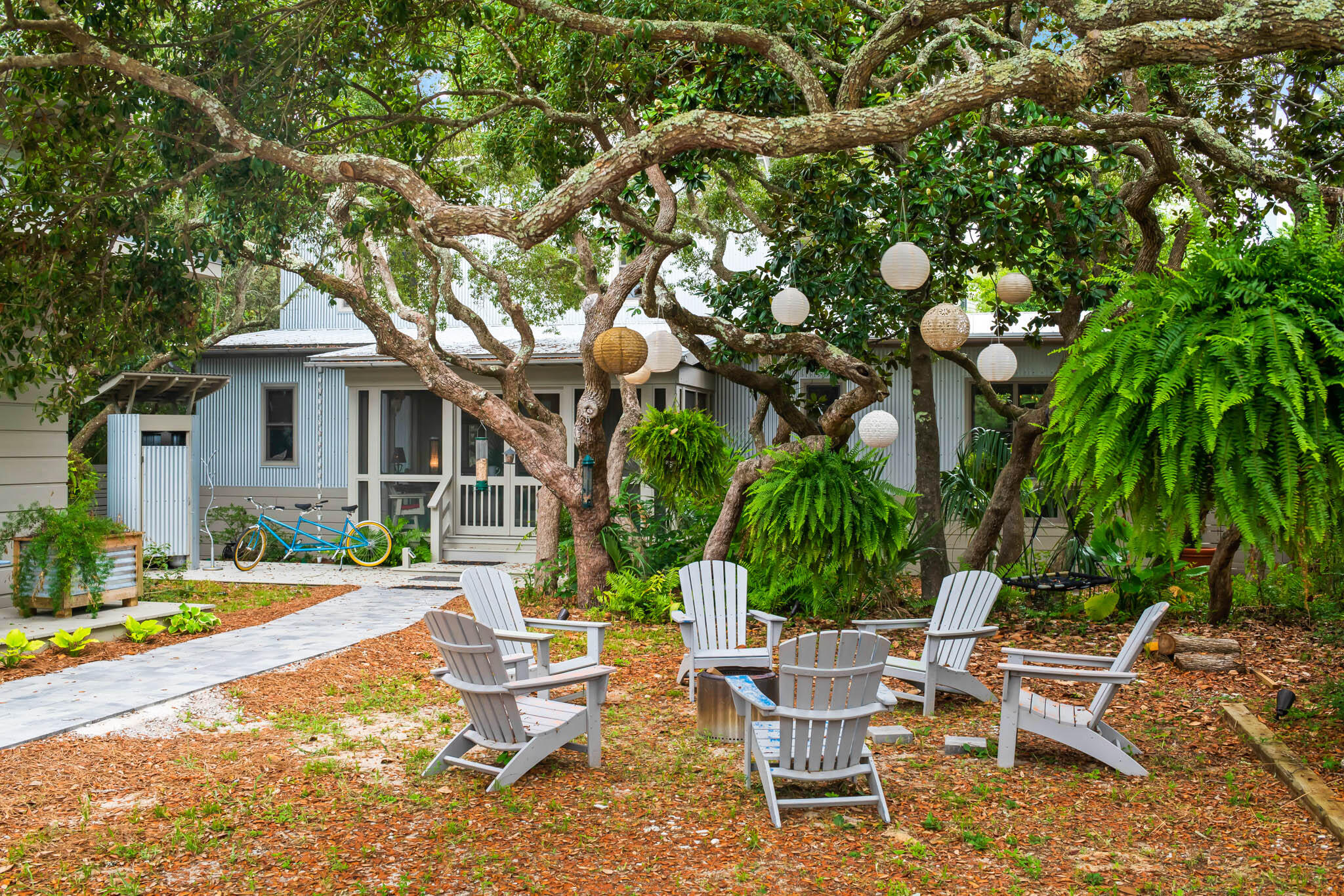 450 Defuniak Street Santa Rosa Beach, FL 32459 - Photo 10 of 75 a view of a house with backyard sitting area and garden