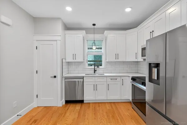a kitchen with stainless steel appliances granite countertop a sink and cabinets