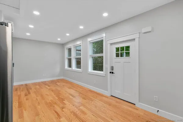 wooden floor in an empty room with a window