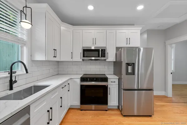 a kitchen with a refrigerator sink and microwave