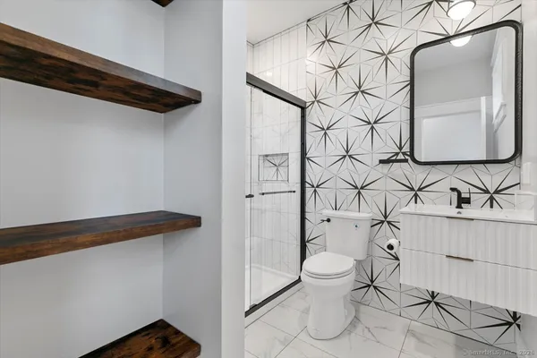 a bathroom with a toilet and a shower curtain