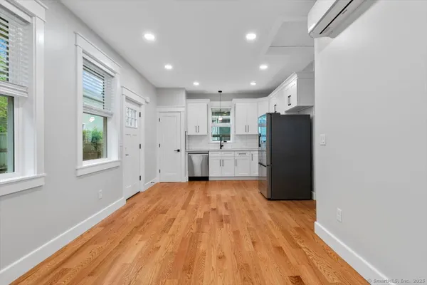 a view of kitchen with refrigerator and window
