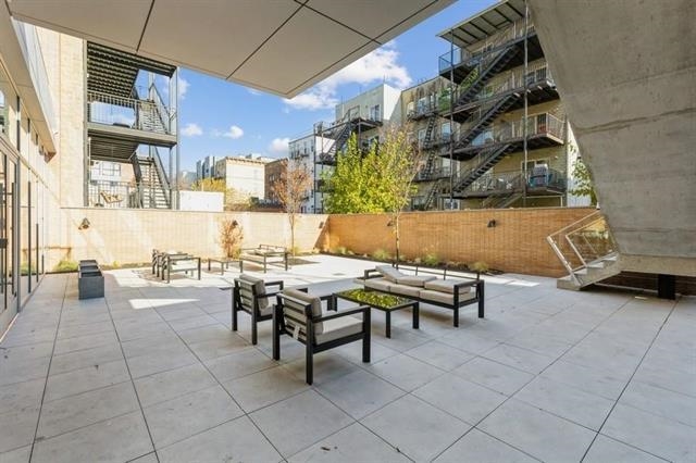 401 Jackson Street, Unit 503 Hoboken, NJ 07030 - Photo 18 of 29 a view of a patio with dining table and chairs