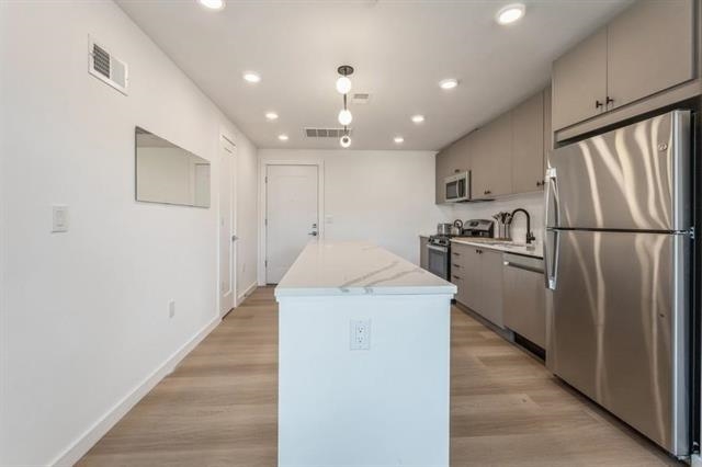401 Jackson Street, Unit 503 Hoboken, NJ 07030 - Photo 26 of 29 a kitchen with a refrigerator a sink and dishwasher
