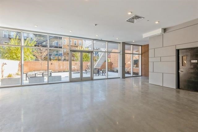 401 Jackson Street, Unit 503 Hoboken, NJ 07030 - Photo 9 of 29 a view of an empty room with a sliding door
