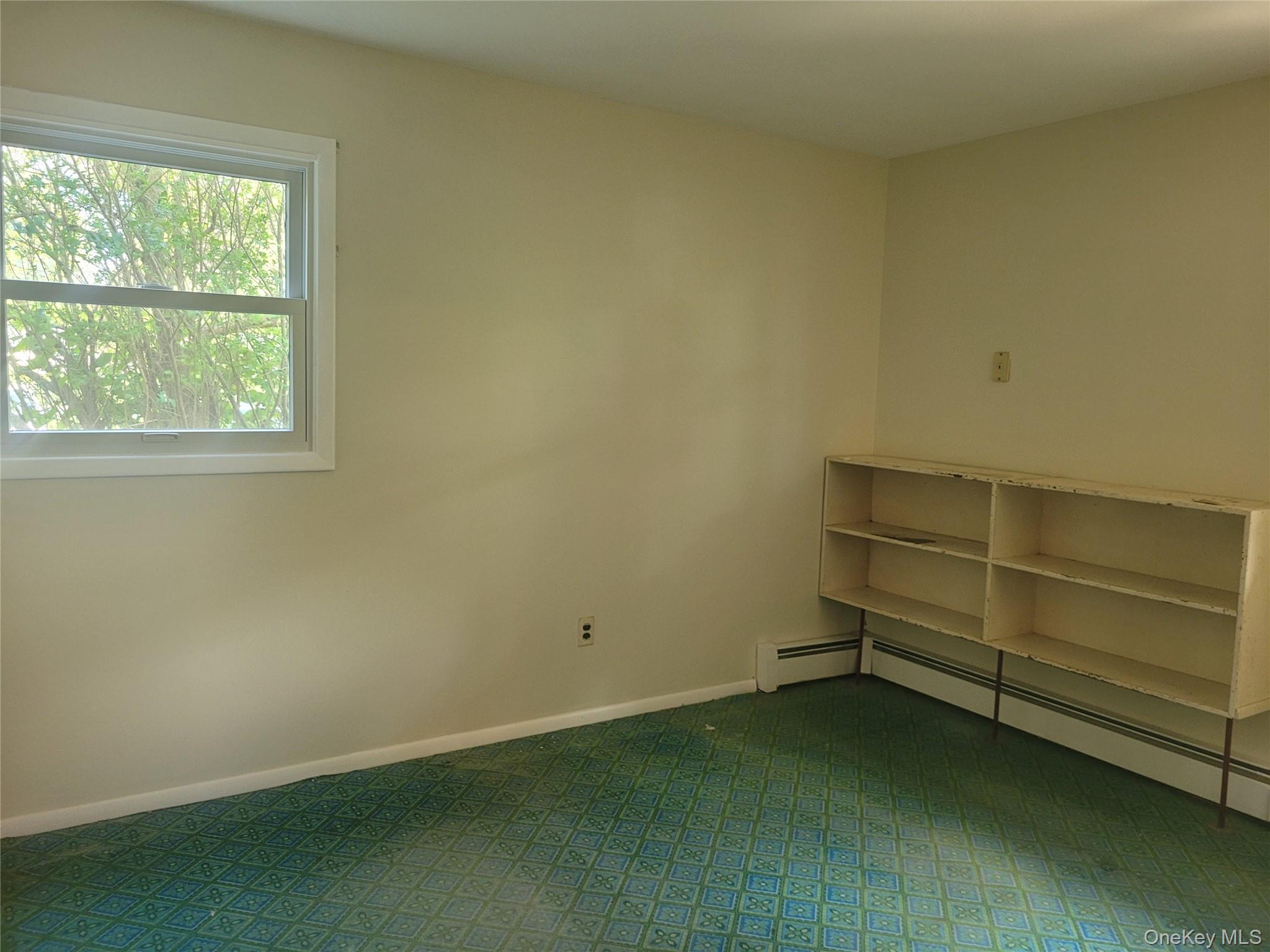 8 Cornell Road East Patchogue, NY 11772 - Photo 10 of 18 an empty room with a empty space and window