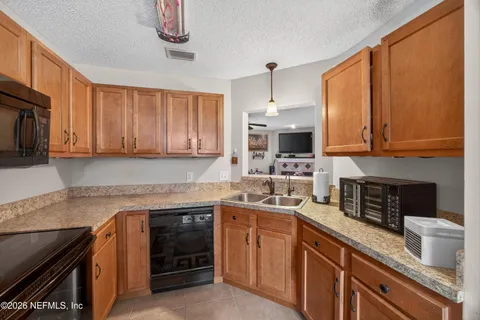 a kitchen with stainless steel appliances granite countertop a stove sink microwave and cabinets