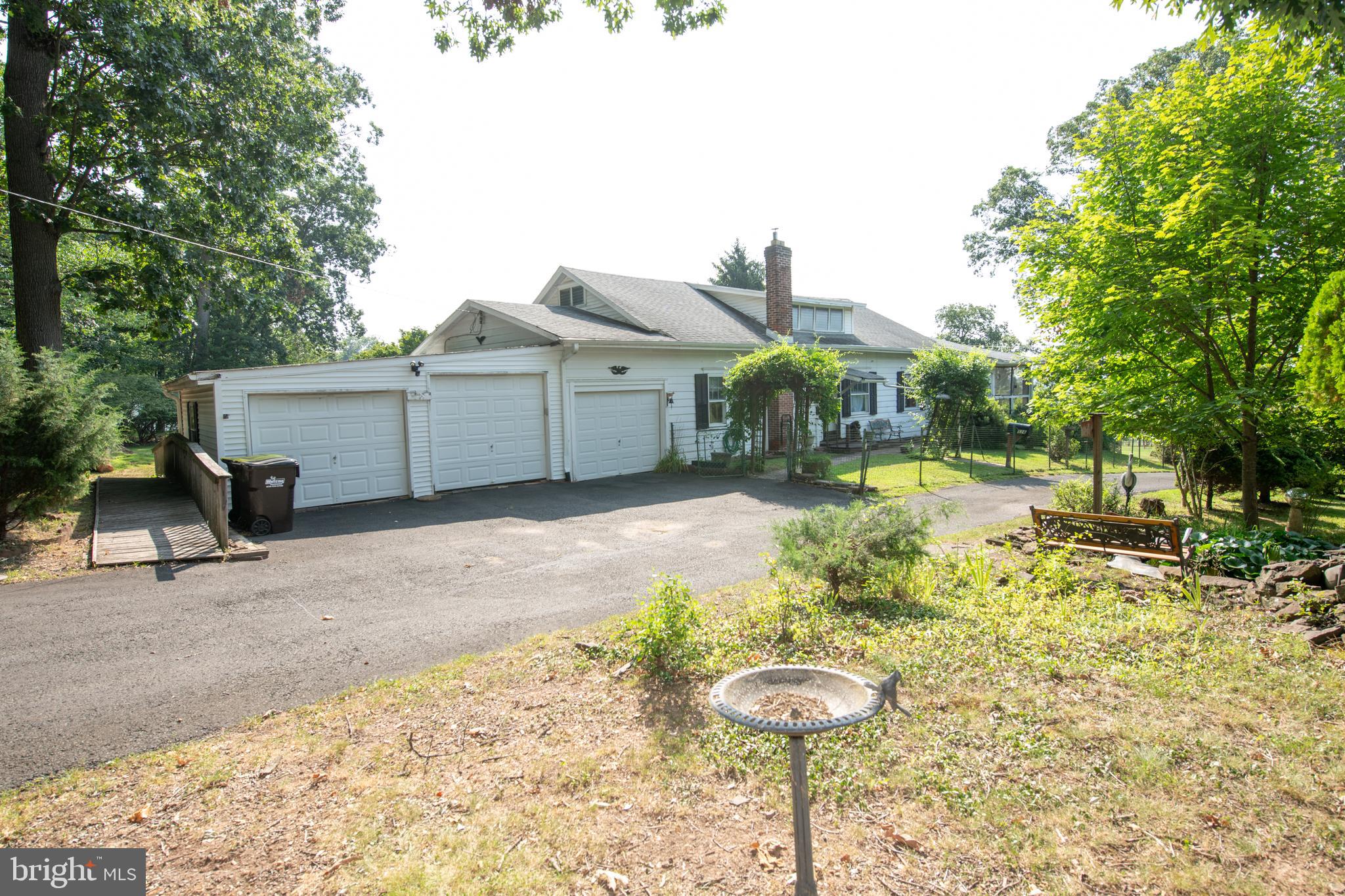 a view of a house with a yard and sitting area