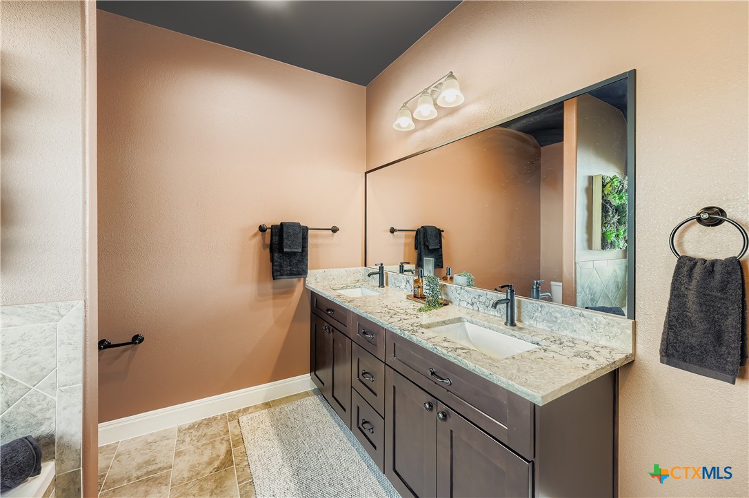 222 Arosa Drive Elgin, TX 78621 - Photo 25 of 40 a bathroom with a sink and a mirror