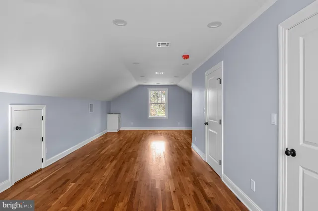 a view of an empty room and wooden floor