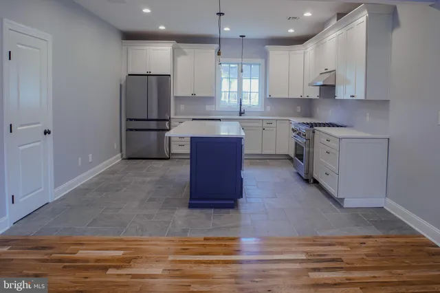 a kitchen with stainless steel appliances granite countertop a refrigerator sink and cabinets