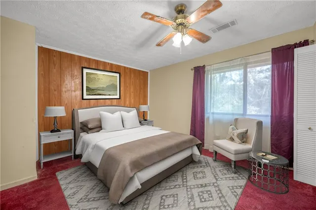 a bedroom with a large bed and a window