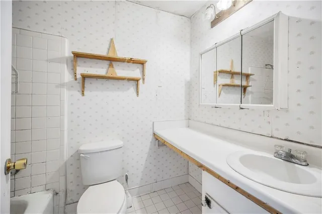 a bathroom with a sink toilet and mirror