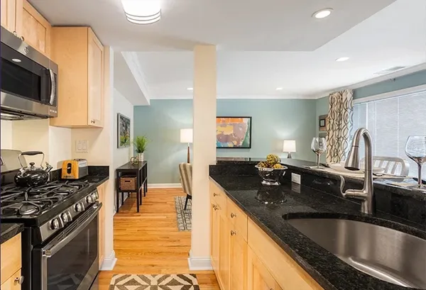 a kitchen with granite countertop a sink and a stove top oven