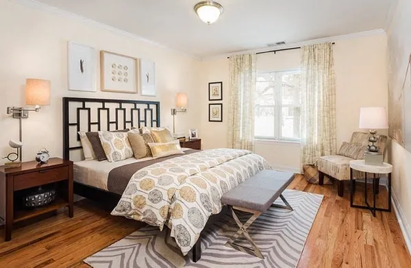 a bedroom with two beds and a large window