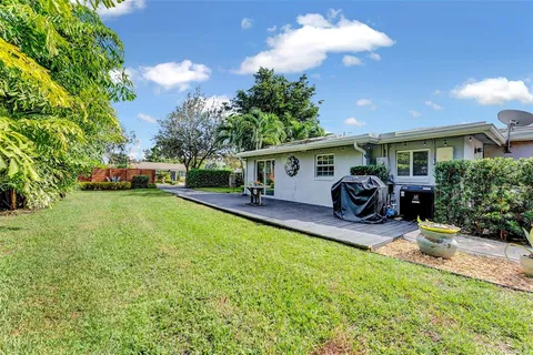 a front view of a house with a yard patio and fire pit