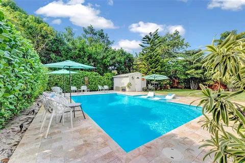 a view of a backyard with sitting area