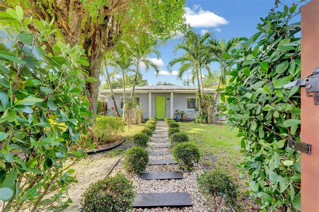 a front view of a house with a garden