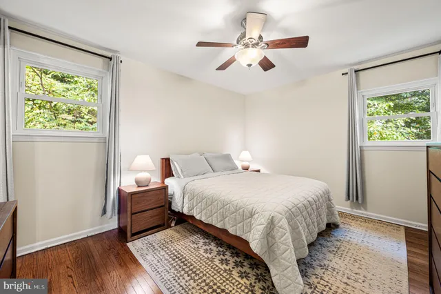 a bedroom with a large bed chandelier and a window