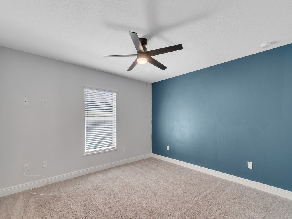 431 Midvale Terrace Sebastian, FL 32958 - Photo 22 of 34 an empty room with windows and fan