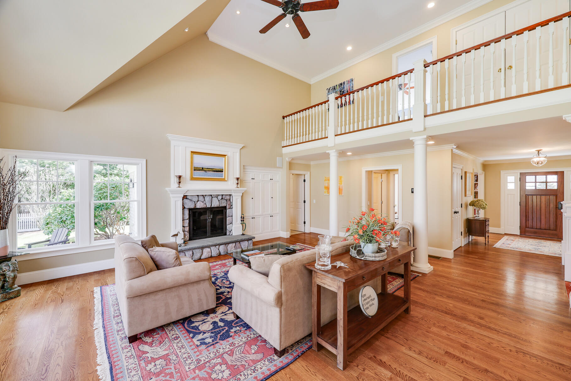 40 Reflection Drive Sandwich, MA 02563 - Photo 3 of 59 a living room with furniture a fireplace and a floor to ceiling window
